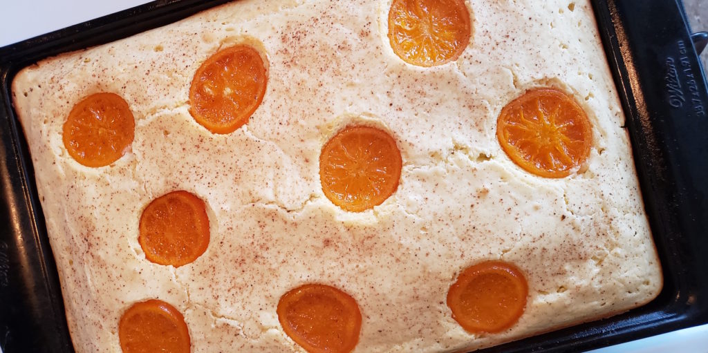 Take the hassle out of cooking breakfast for a crowd with these super easy, delightfully tasty candied orange sheet pan pancakes with warm spiced syrup.