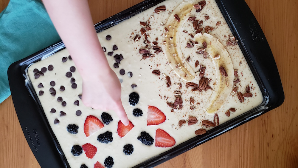 Take the hassle out of cooking breakfast for a crowd with these super easy, delightfully tasty sheet pan pancakes!