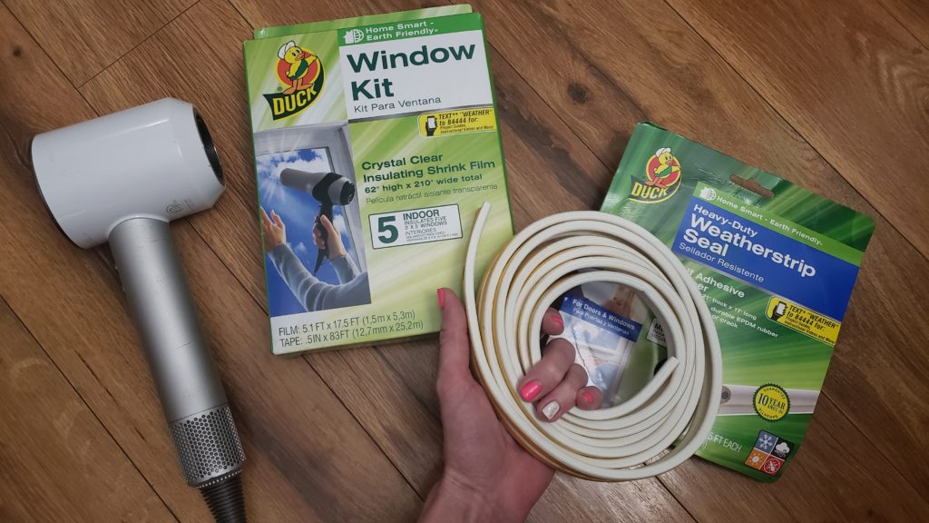 Quick fix for a drafty house with weatherstripping and window wrapping.