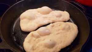 Easy herbed garlic naan! Made with yogurt or sour cream, this fluffy bread recipe will be a new favorite. So quick and delicious!