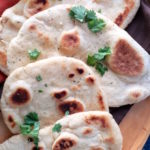 Easy herbed garlic naan! Made with yogurt or sour cream, this fluffy bread recipe will be a new favorite. So quick and delicious!